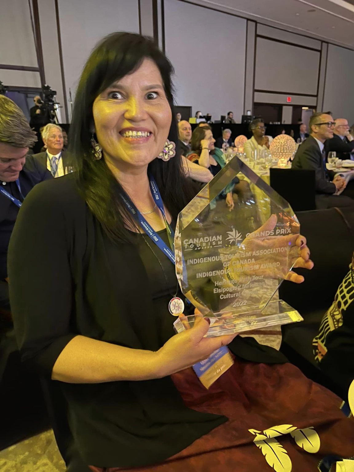 Mi'kmaw women holds glass trophy for National Indigenous Tourism Business 